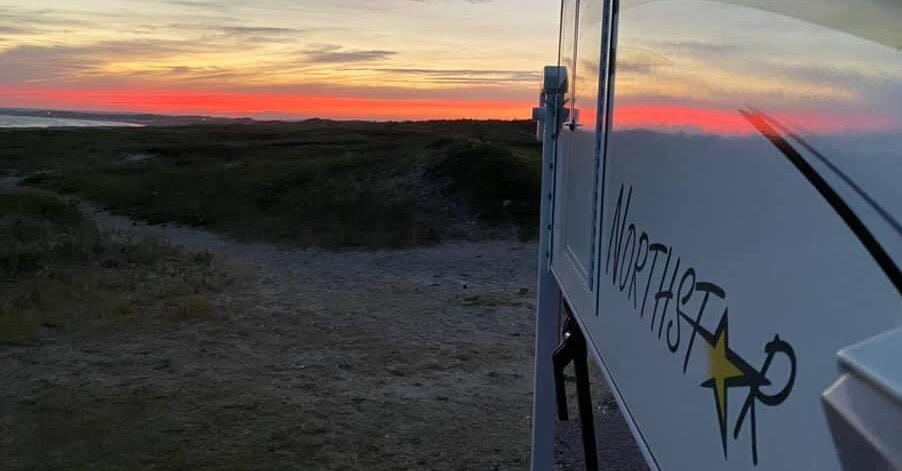 The glow extending to the camper at Horseneck Beach